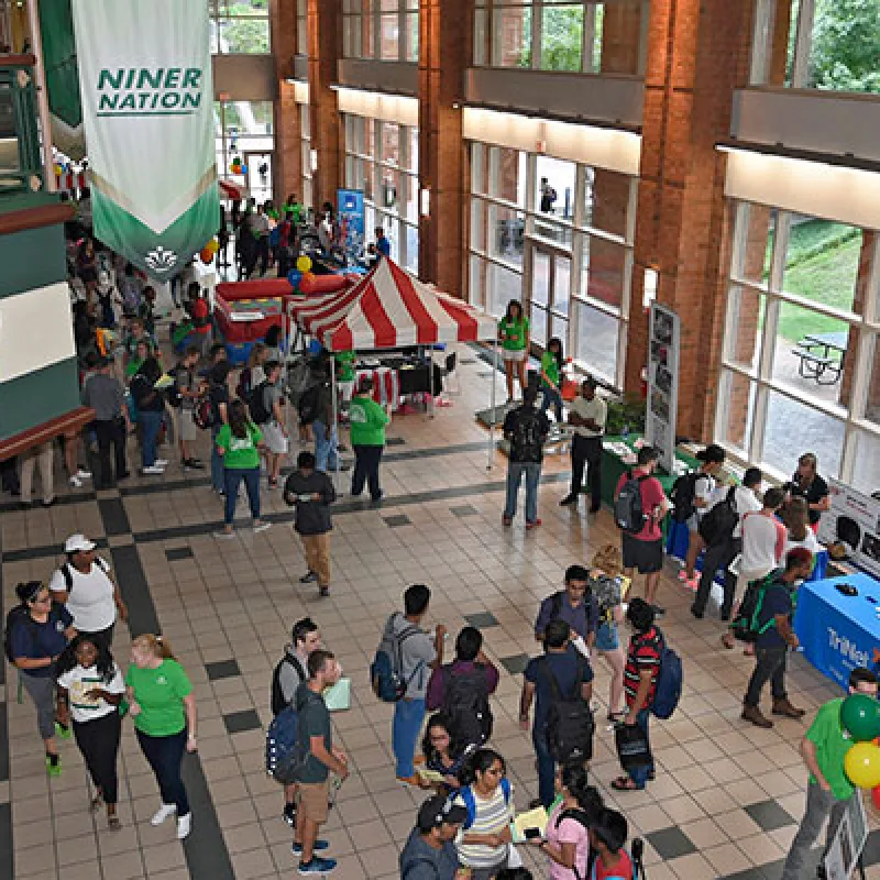 Aerial view of crowd of students gathered around information booths.